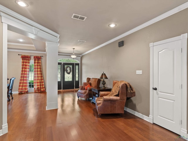 entryway with hardwood / wood-style floors, decorative columns, and crown molding