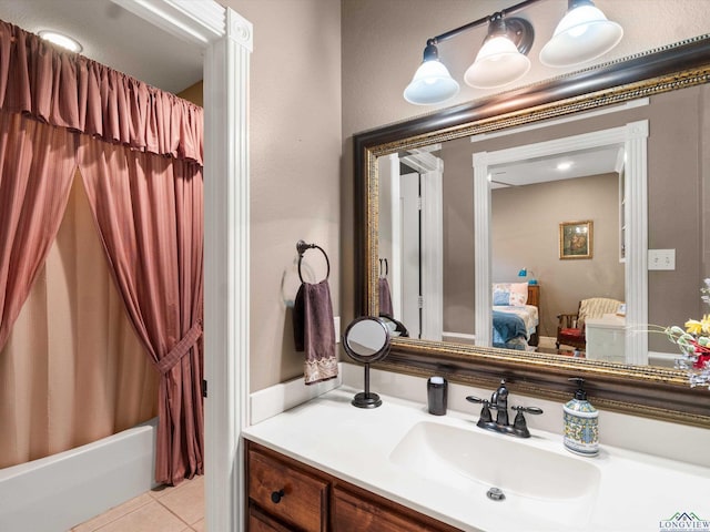 bathroom featuring shower / bath combo with shower curtain, tile patterned flooring, and vanity