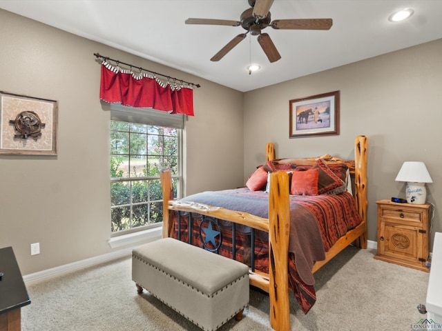 bedroom featuring light colored carpet and ceiling fan