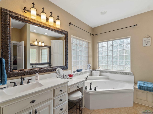 bathroom with tile patterned flooring, vanity, and a tub