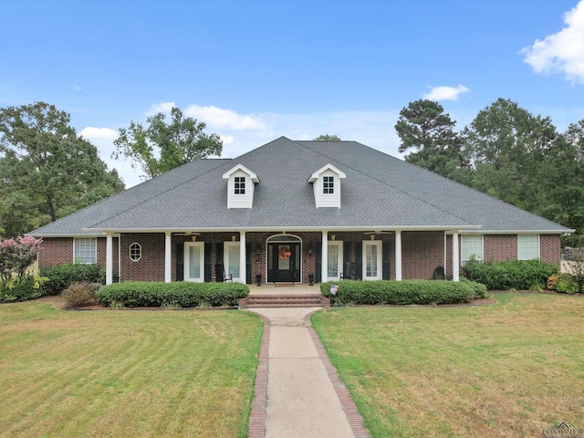 view of front of property featuring covered porch and a front lawn