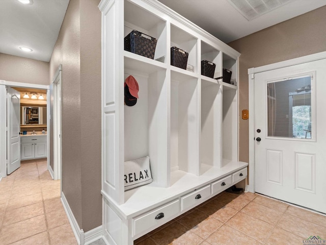 mudroom with light tile patterned flooring