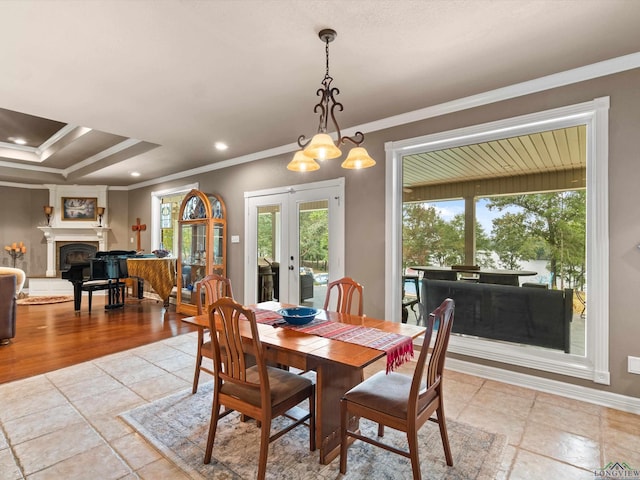 dining space featuring french doors, a notable chandelier, and ornamental molding