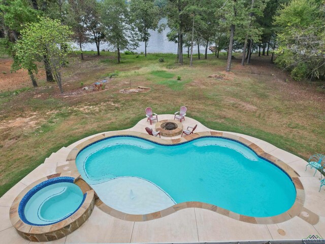 view of pool featuring a patio and a fire pit