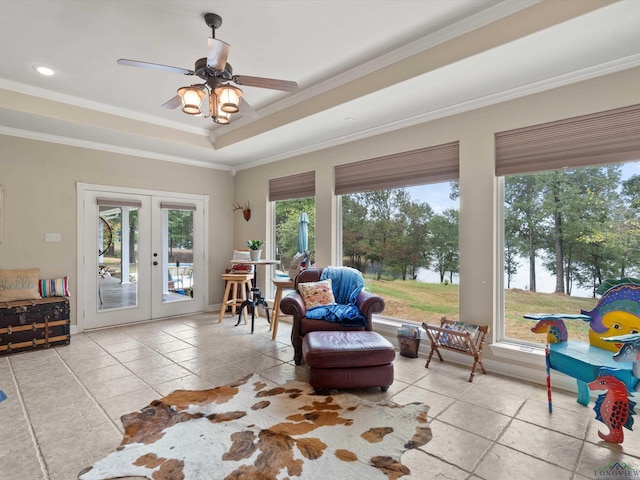 sunroom / solarium featuring ceiling fan, a tray ceiling, and french doors