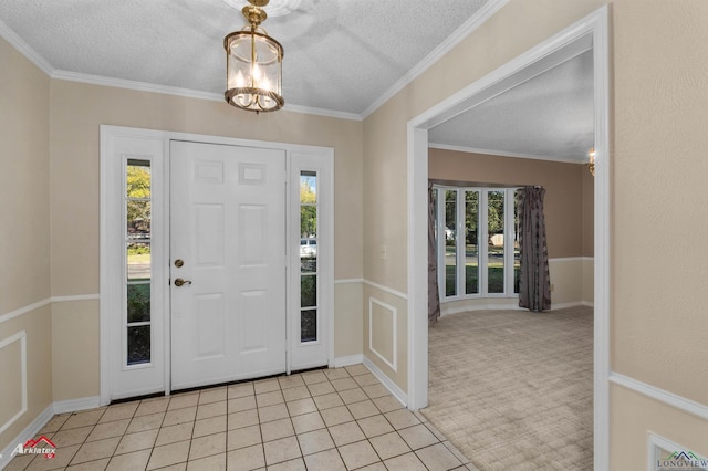 tiled foyer with a notable chandelier, crown molding, and a textured ceiling