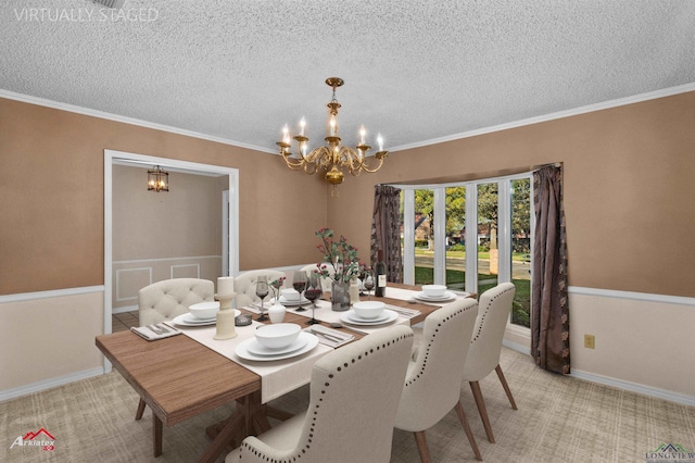 dining space featuring a chandelier, a textured ceiling, and crown molding