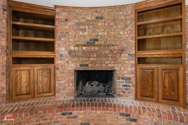 unfurnished living room featuring built in shelves and a brick fireplace