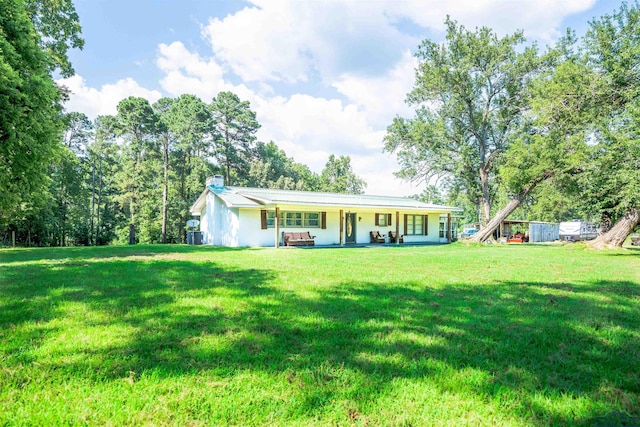 single story home featuring a front lawn