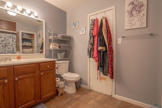 bathroom featuring vanity, curtained shower, and toilet