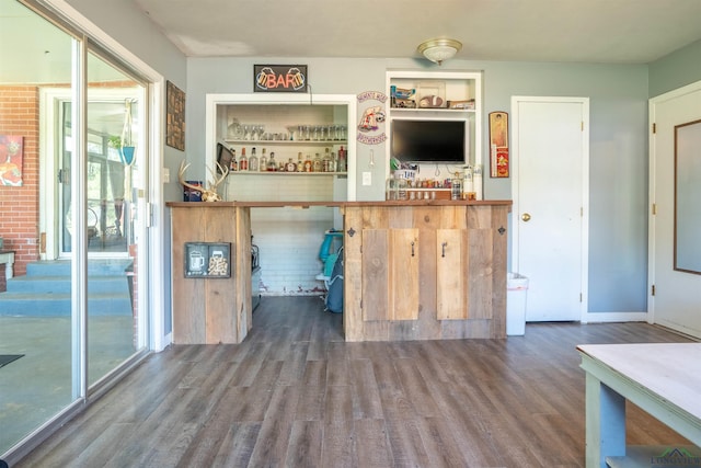 bar featuring wood-type flooring and brick wall