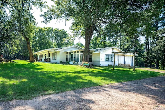 single story home featuring a garage and a front lawn