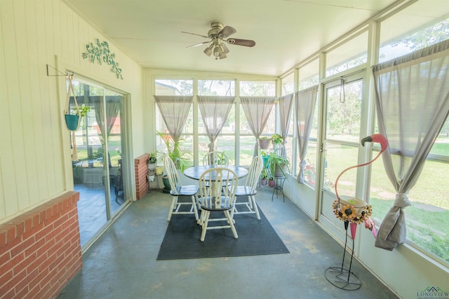 unfurnished sunroom featuring ceiling fan