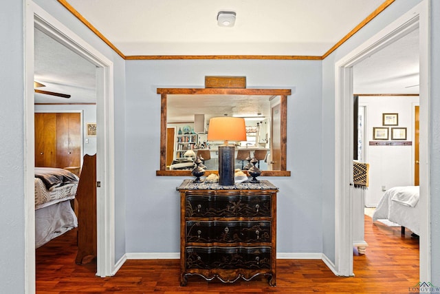 hallway featuring hardwood / wood-style flooring and crown molding