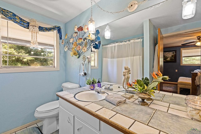 bathroom featuring tile patterned floors, vanity, toilet, and ceiling fan