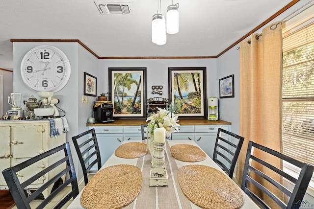 dining area featuring crown molding