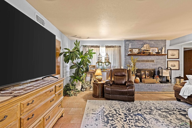 tiled living room featuring a fireplace and a textured ceiling