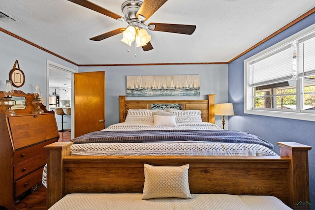 bedroom with a textured ceiling, ceiling fan, and crown molding