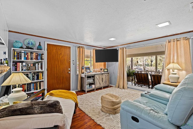 living room featuring a textured ceiling, dark hardwood / wood-style floors, a healthy amount of sunlight, and crown molding