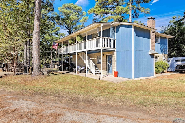 rear view of property featuring a lawn