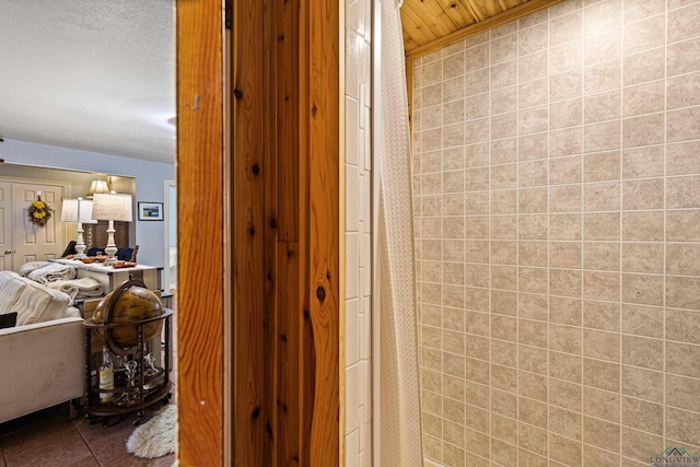 bathroom with tile patterned floors and wood ceiling