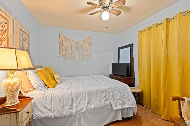 bedroom with ceiling fan and light tile patterned flooring