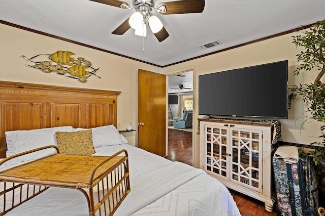 bedroom featuring ceiling fan, dark hardwood / wood-style flooring, a textured ceiling, and ornamental molding