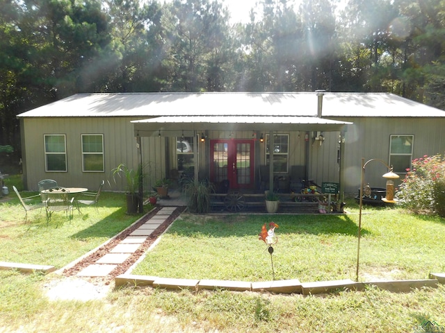 exterior space with a yard and french doors