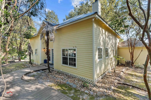 rear view of property with central air condition unit