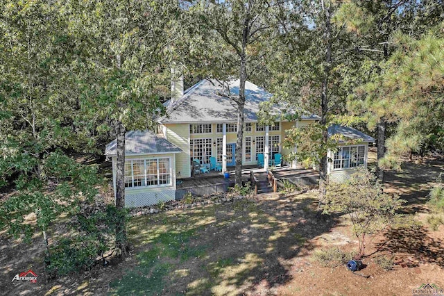 rear view of property featuring a wooden deck and french doors