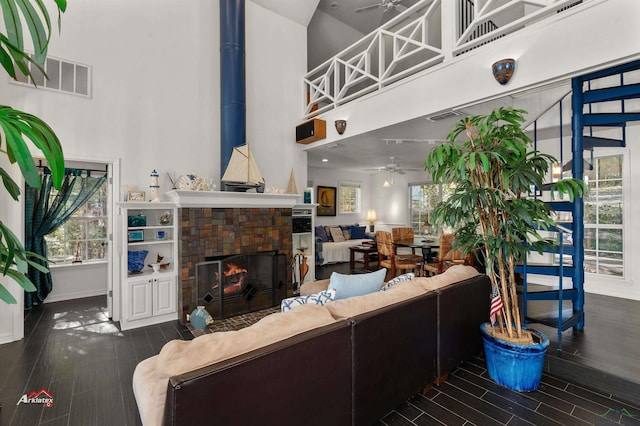 living room with a towering ceiling and ceiling fan