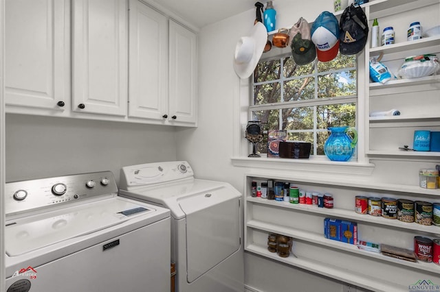 laundry area with independent washer and dryer and cabinets