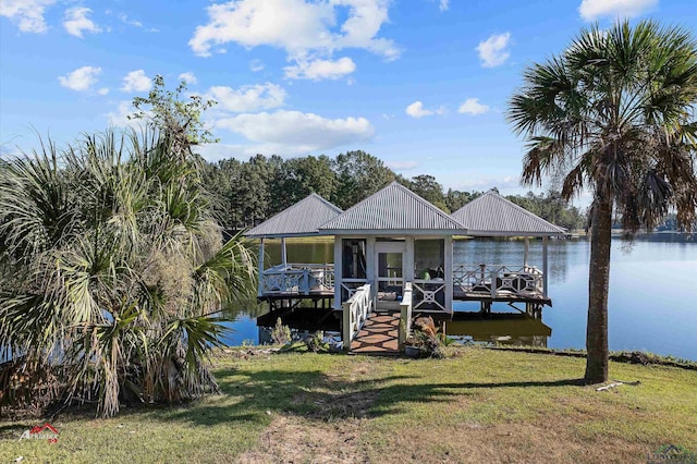 view of dock featuring a water view and a yard