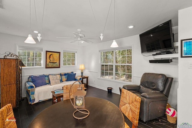 living room with dark hardwood / wood-style flooring and ceiling fan