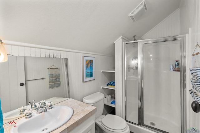 bathroom with lofted ceiling, vanity, toilet, and an enclosed shower