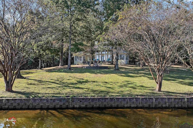 exterior space featuring a water view and a yard