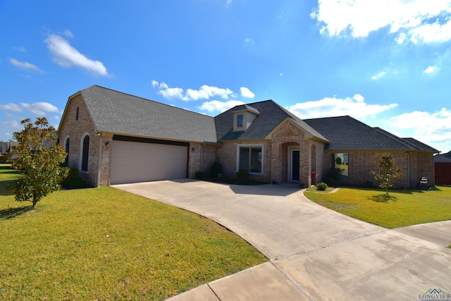 view of front of property featuring a garage and a front lawn