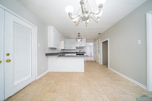 kitchen with decorative light fixtures, white cabinets, a textured ceiling, and kitchen peninsula