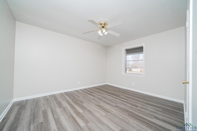 empty room with ceiling fan and light wood-type flooring