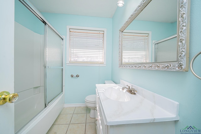 full bathroom with vanity, tile patterned floors, toilet, and combined bath / shower with glass door