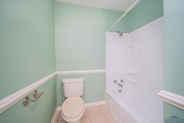 bathroom with tile patterned flooring, shower / bathtub combination, and toilet