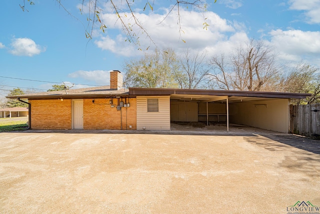 rear view of property featuring a carport