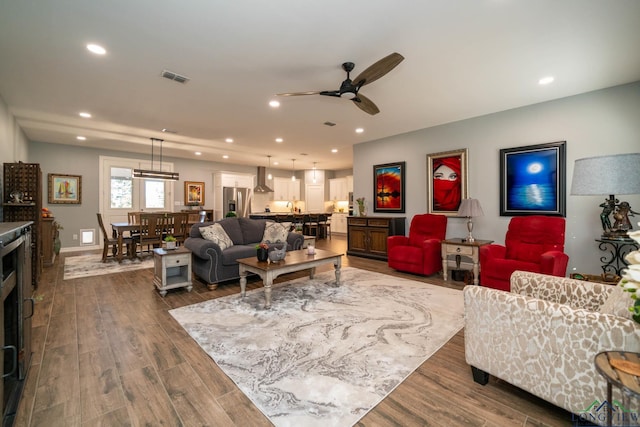 living room featuring dark hardwood / wood-style flooring and ceiling fan