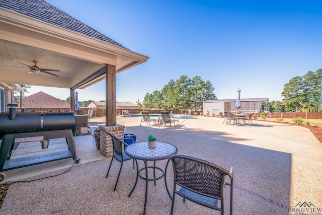 view of patio / terrace featuring a fenced in pool and ceiling fan