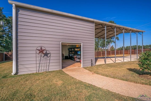 view of outbuilding featuring a lawn