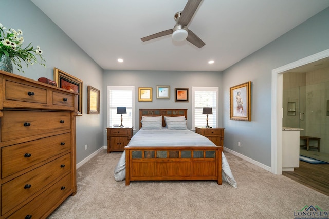 bedroom featuring ensuite bath, ceiling fan, and light carpet