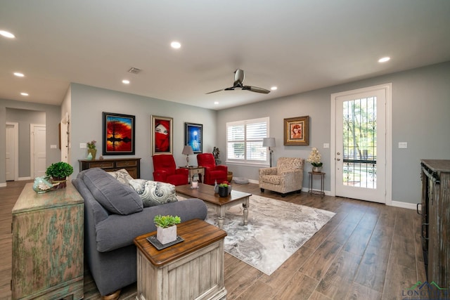 living room with ceiling fan and dark hardwood / wood-style floors