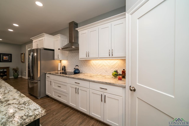 kitchen featuring white cabinetry, light stone countertops, wall chimney exhaust hood, dark hardwood / wood-style floors, and black electric cooktop