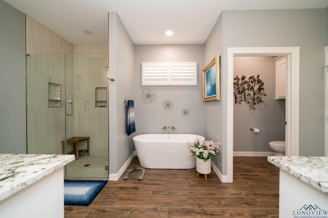 full bathroom featuring vanity, toilet, and shower with separate bathtub