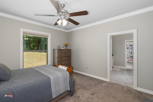 bedroom featuring ceiling fan, ensuite bathroom, ornamental molding, and light carpet